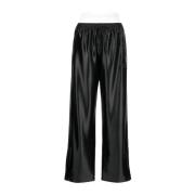 Alexander Wang Svarta track pants med integrerad trosa och staplad Wan...